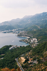 Fototapeta na wymiar View from the mountain of the rugged coast of the Bay of Kotor with resort towns. Montenegro