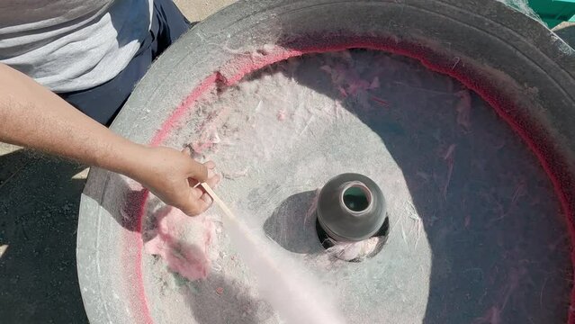 Pouring sugar into cotton candy machine