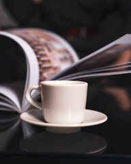 Close-up of a white cup and saucer on a wood table