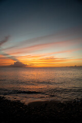 Beautiful colored sunset sky over Caribbean Sea from Saint Lucia beach.  Shot on a mirrorless camera with pink, orange, and blue colors in the sky.