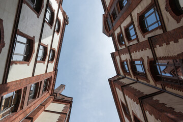 Fototapeta na wymiar View upwards in the courtyard of a brick building in Hamburg, Germany