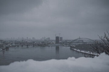 KYIV, UKRAINE - DECEMBER 8, 2023: SINCE THE MORNING, THE CITY WAS HEAVILY SNOWED. VIEW OF THE DNIPRO RIVER FROM THE SNOW BRIDGE