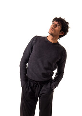 Fototapeta premium A man standing with his hands in his pockets, looking up, isolated on white background in studio shot