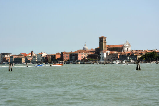 Distant view of the coast of Venice, Italy with historic architecture and motor boats