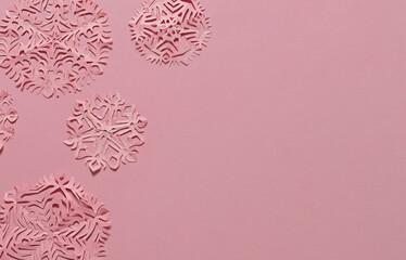 Hand cut diy pink paper snowflakes. Copy space