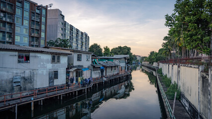 A picture of a canal that flows through the riverside village There were fences on both sides of...