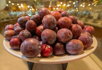 Angelika plums in a large white plate.