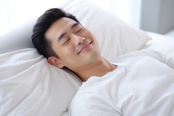 Obraz na płótnie Canvas Asian Man Happily Sleeping On White Bed With White Blanket. Сoncept Minimalist Bedroom, Serene Slumber, Tranquil Rest, Peaceful Nap
