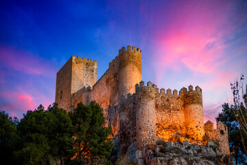 Spectacular view of the medieval castle of Almansa, Albacete, Spain, on a cliff at dawn