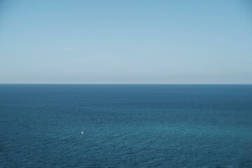 blue sea and sky and a lone boat