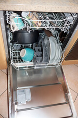 Open dishwasher filled with dishes