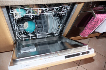 Open dishwasher filled with dishes