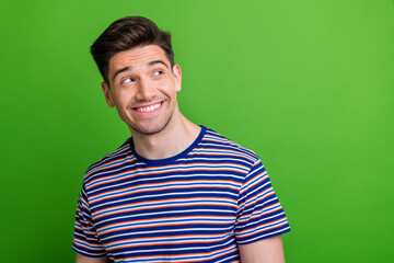 Photo of nice cheerful minded person beaming smile look empty space contemplate isolated on green color background