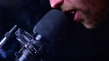 Man talking to the microphone isolated on  dark background