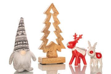 Two ceramic Christmas deer, wooden Christmas tree and gnome, macro, isolated on white background.