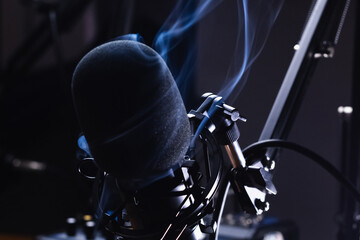 Podcast microphone setup on dark background copy space image, abstract smoke podcasting, music,...