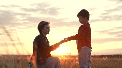 Boy extends hand to mother signifying sense of trust. Boy through connection experiences care with...