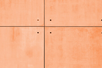Concrete texture tiles as a background toned in peach fuzz color of the year 2024