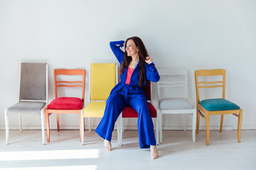 Brunette woman 40 years old sitting on a chair