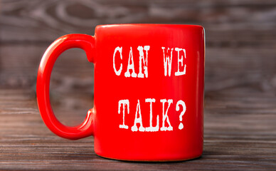 CAN WE TALK? - word on a red cup on a dark background.