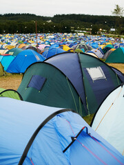 Tent, field and outdoor for music festival or camping in nature, summer or forest for adventure or vacation. Event, campsite or setup for sleeping, rest or shelter in woods, trees or environment © Mariusz S/peopleimages.com