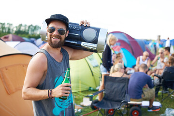 Music festival, alcohol and man with boombox outdoors for social party, celebration and camp event....
