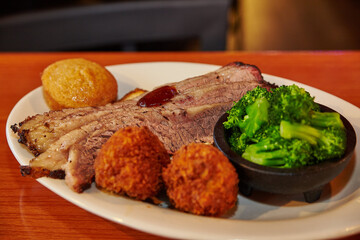 Hearty Southern BBQ Feast with Brisket and Hushpuppies in Restaurant Setting