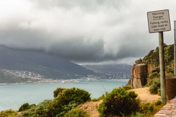 Foto auf Leinwand Hout Bay, a fishery town on the Cape Peninsula south of Cape Town, South Africa, is seen from Chapman's Peak under stormy spring skies © Colin N. Perkel