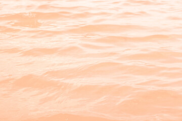 Color of the year 2024. Peach fuzz. Wave water background design. An abstract background of...