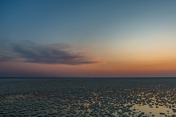 Sunset or sunrise on salt lake Elton (Russia) with mirror or reflection of low Cumulostratus or...