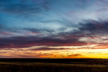 Sunrise or sunset in the Russian steppe at golden hour. Stratus, Cirrocumulus and Altocumulus...