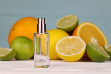Perfume with citrus extracts. Selective focus. Spa day, concept of freshness perfume bottle with lemon lime and orange slices