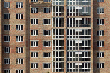 View of a large construction site with buildings under construction and multi-storey residential homes. Housing renovation concept