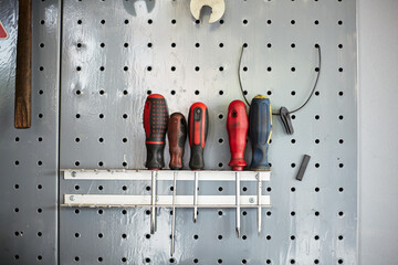 A screwdriver on a rack in a bicycle workshop