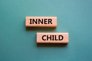 Inner Child symbol. Wooden blocks with words Inner Child. Beautiful grey green background. Business...