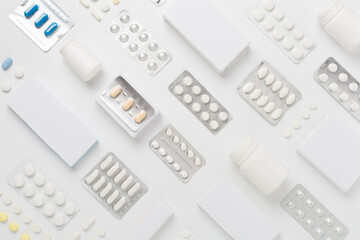 Flat lay with different pills in blister packaging and boxes and on color background