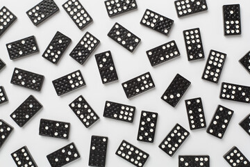 Black domino tiles on white background, top view