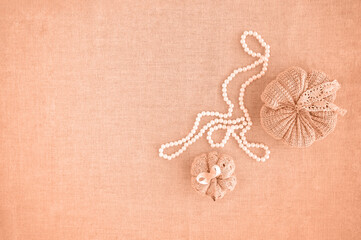 Hobby background with handmade knit pumpkins and white pearl beads. DIY, craft decoration for fall...