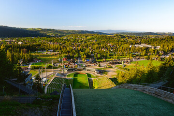 Wielka Krokiew, view from the top of the ski jump towards the stands and part of the city of Zakopane. - obrazy, fototapety, plakaty