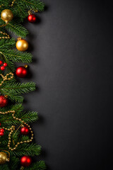 Black christmas flat lay background. Christmas tree with holidays decorations at black background.
