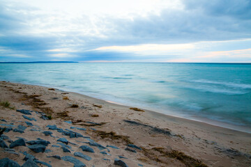 Serene Sunrise Over Lake Michigan's Rocky Blurred Beachscape