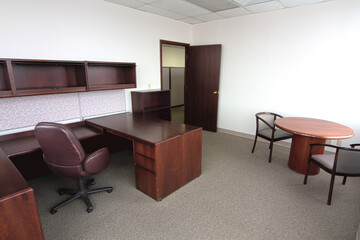 Traditional Empty Office Space with L-Shaped Desk and Meeting Table