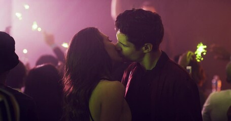 Couple, kiss and lights in a nightclub for dancing, fun and a night out at a new years event. Crowd, people or man and a woman at a disco, club or party with entertainment and love with music - Powered by Adobe