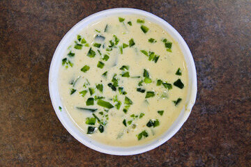 Top-Down View of Creamy Authentic Mexican Queso in Rustic Kitchen Setting