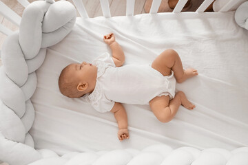 Little cute baby sleeping in crib at home