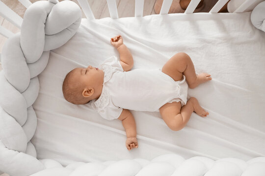 Little cute baby sleeping in crib at home