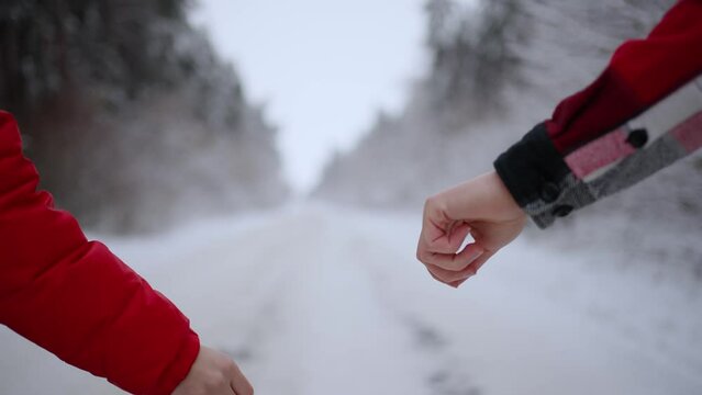 A woman's hand lets go of a man's hand