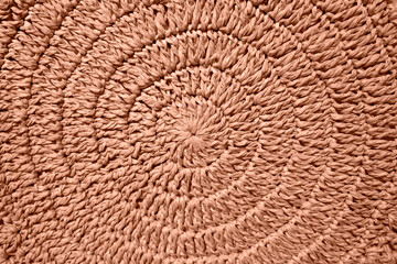 Natural woven straw texture. Peach fuzz is color of year 2024.