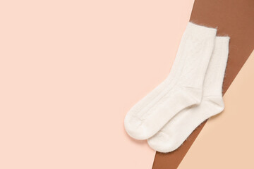 White knitted socks on colorful background