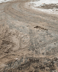 The tread marks of car tires on winter road.